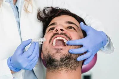 man being fitted for new Invisalign clear aligners at Serenity Dental in Spokane Valley, WA