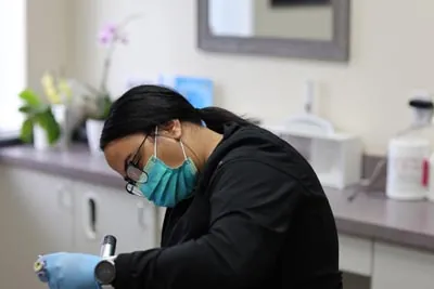 hygienist cleaning a patient's teeth at Serenity Dental in Spokane, WA